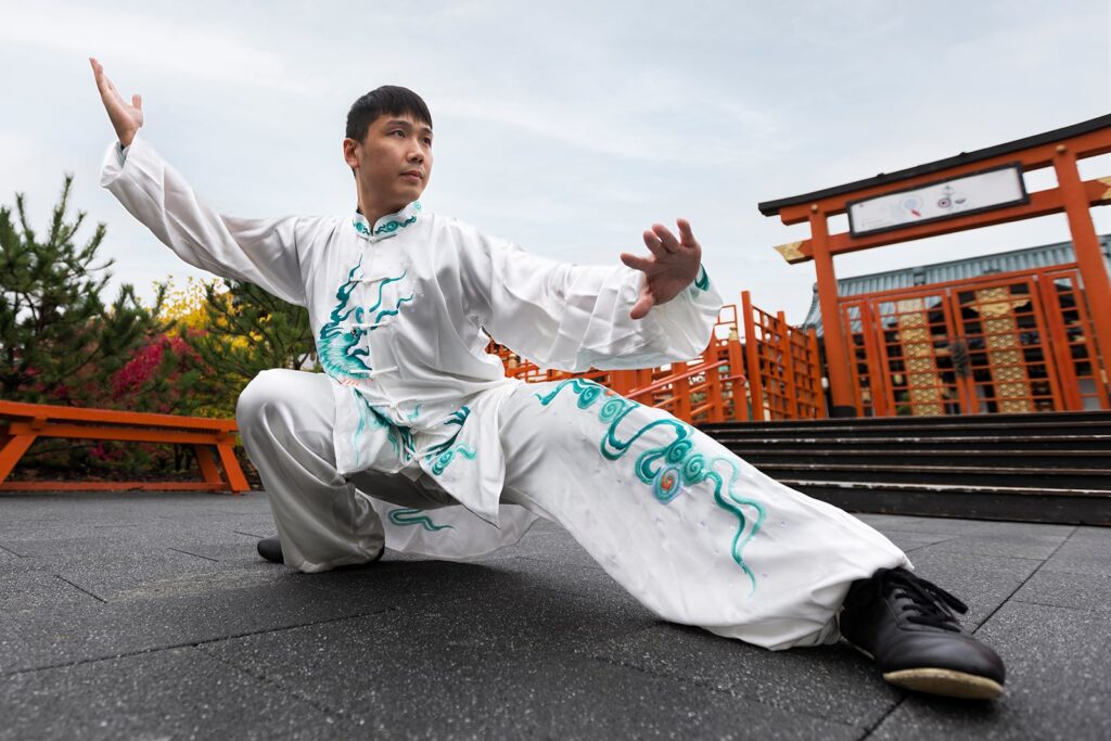 full-shot-man-practicing-tai-chi-outdoors-min